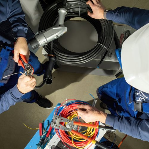 Engineers,Try,To,Put,Cables,In,Plug,To,Charge,Electric Engineers try to put cables in plug to charge electric car. Foremen use pliers and install cables in adapter for electric cars on stations